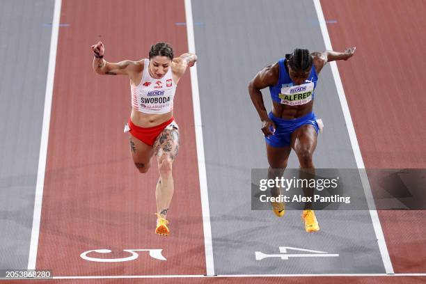 Julien Alfred of Team Saint Lucia crosses the finish line before Ewa Swoboda of Team Poland to win the Women's 60 Metres Final on Day Two of the...