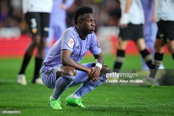 Vinicius Junior of Real Madrid reacts as Mouctar Diakhaby of Valencia CF receives medical treatment before being stretchered off the pitch with an...