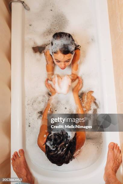 children having fun with bubble bath at home - girl shower stock pictures, royalty-free photos & images