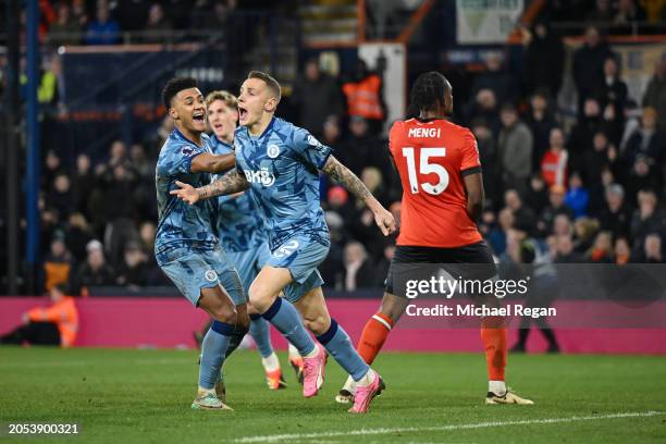 Lucas Digne of Aston Villa celebrates scoring his team's third goal with team mate Ollie Watkins during the Premier League match between Luton Town...