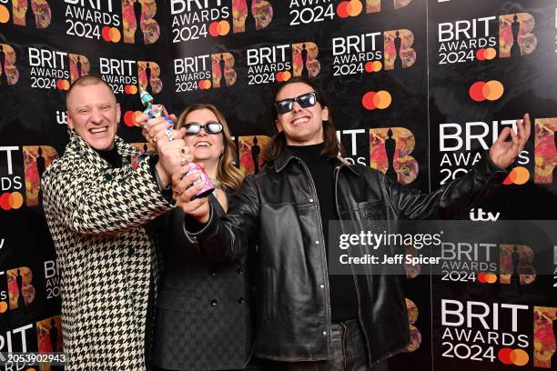 Tom McFarland, Lydia Kitto and Josh Lloyd-Watson of Jungle pose with their Group of the Year Award during the BRIT Awards 2024 at The O2 Arena on...