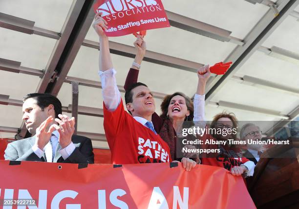 Local politicians are seen on stage as more than a thousand nurses and Safe Staffing supporters rally at the Capitol calling for the passage of the...