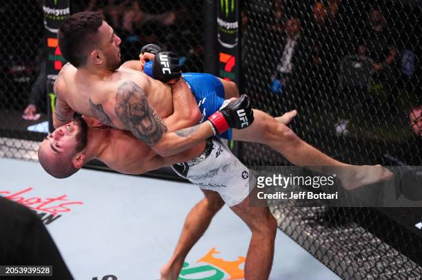Muhammad Mokaev of Russia takes down Alex Perez in a flyweight bout during the UFC Fight Night event at UFC APEX on March 02, 2024 in Las Vegas,...