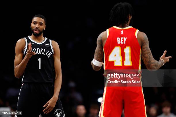 Mikal Bridges of the Brooklyn Nets celebrates scoring during the second half as Saddiq Bey of the Atlanta Hawks reacts at Barclays Center on March...