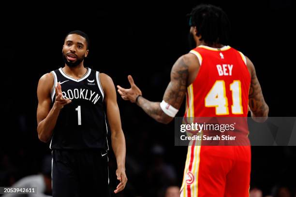 Mikal Bridges of the Brooklyn Nets celebrates scoring during the second half as Saddiq Bey of the Atlanta Hawks reacts at Barclays Center on March...