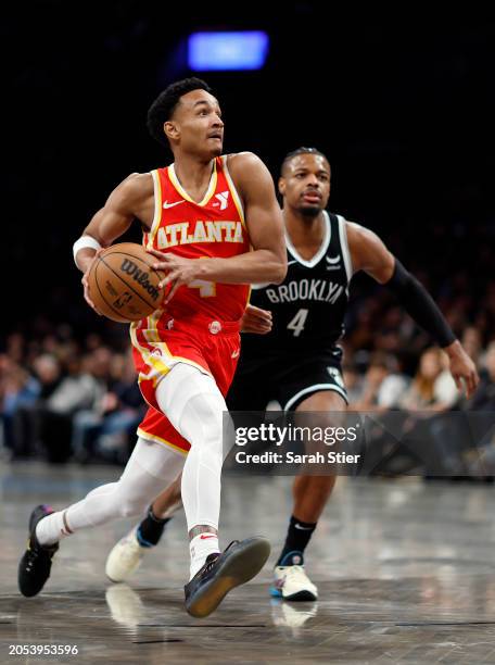 Kobe Bufkin of the Atlanta Hawks dribbles as Dennis Smith Jr. #4 of the Brooklyn Nets defends during the second half at Barclays Center on March 02,...