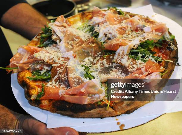 Owner John Isopo holds a Rinaldo pizza at Anna's Wood Fired Pizza on Tuesday, April 21, 2016 in Latham, N.Y. The Rinaldo has fresh mozzarella, tomato...