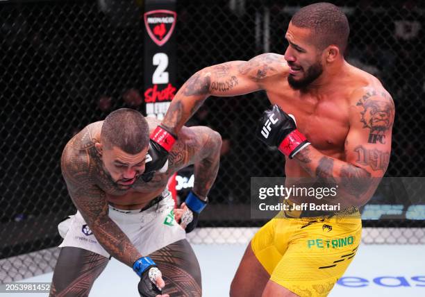 Vitor Petrino of Brazil punches Tyson Pedro of Australia in a light heavyweight bout during the UFC Fight Night event at UFC APEX on March 02, 2024...