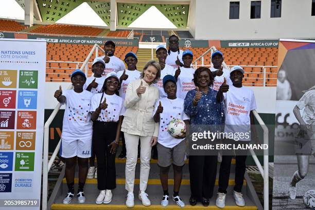 Queen Mathilde of Belgium and Ivorian Minister of Planning and Development Kaba Niale pose with young athletes at a meeting with Ivorian athletes, at...