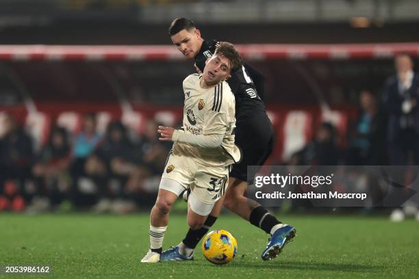 Tommaso Baldanzi of AS Roma is upended by Valentin Carboni of AC Monza during the Serie A TIM match between AC Monza and AS Roma - Serie A TIM at...