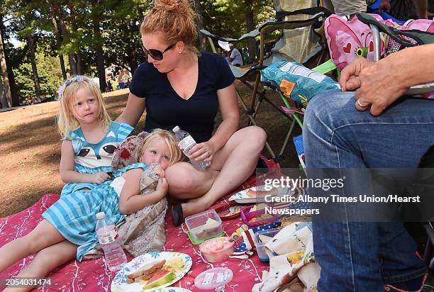 Shelby Parsons of Charlton has a picnic on the lawn with her twin 4 yr-old daughters Claire, sitting up, and Evelyn, and her mother Lynn Ceraldi,...