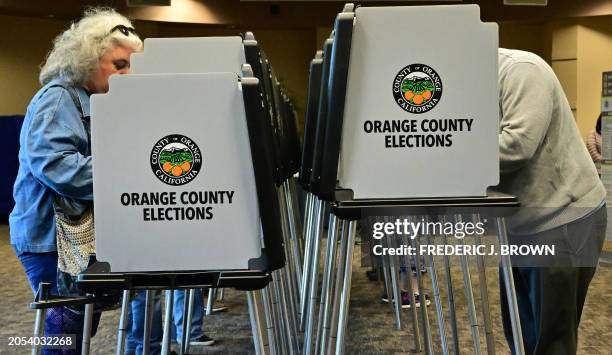 People vote on "Super Tuesday," March 5, 2024 at the Central Library in Huntington Beach, California. Americans from 15 states and one territory vote...