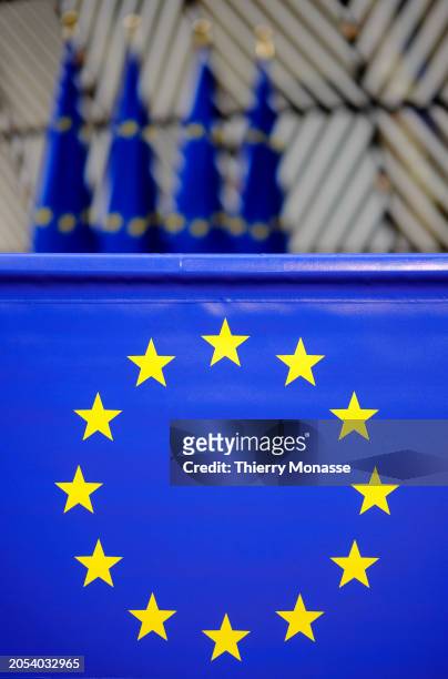 Flags are seen in the atrium of the Europa, the EU Council headquarter on March 5, 2024 in Brussels, Belgium. The EU flag is designed with twelve...