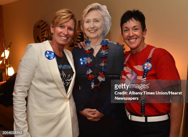 Laurie McBain, left, and Kimberly Powell stand next to a Hillary Clinton cardboard cutout at an election night viewing party hosted by Powell and her...