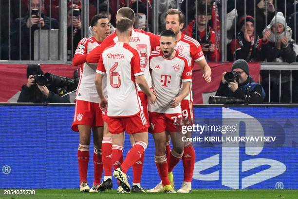 Bayern Munich's English forward Harry Kane celebrates scoring the opening goal with his teammates during the UEFA Champions League round of 16,...