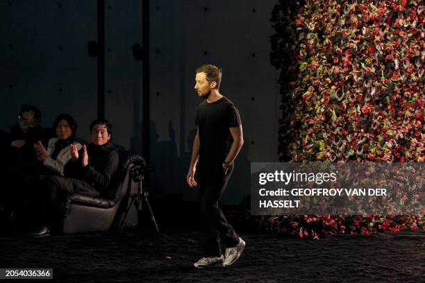 Belgian-Italian fashion designer Anthony Vaccarello acknowledges the applause at the end of his show presenting creations by Saint Laurent for the...