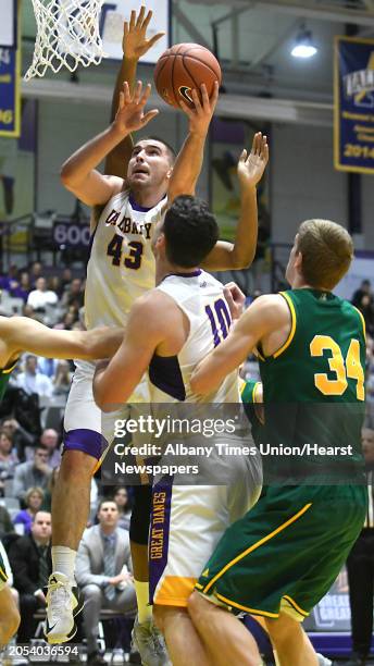 University at Albany's Greig Stire drives to the basket during a basketball game against Vermont at the SEFCU Arena on Wednesday, Jan. 25, 2017 in...