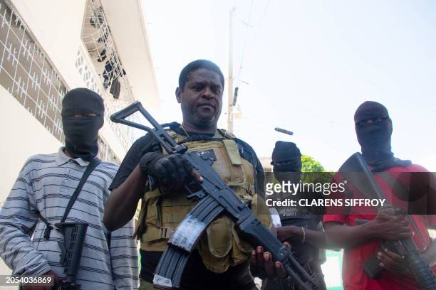 Armed gang leader Jimmy "Barbecue" Cherizier and his men are seen in Port-au-Prince, Haiti, March 5,2024. Haiti's police academy came under attack by...