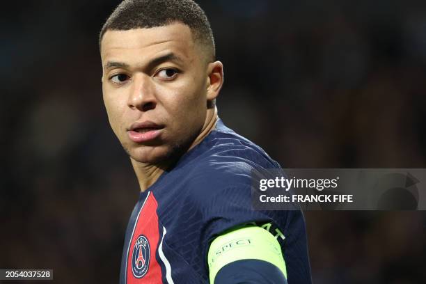 Paris Saint-Germain's French forward Kylian Mbappe looks backwards during the UEFA Champions League last 16 second leg football match between Real...