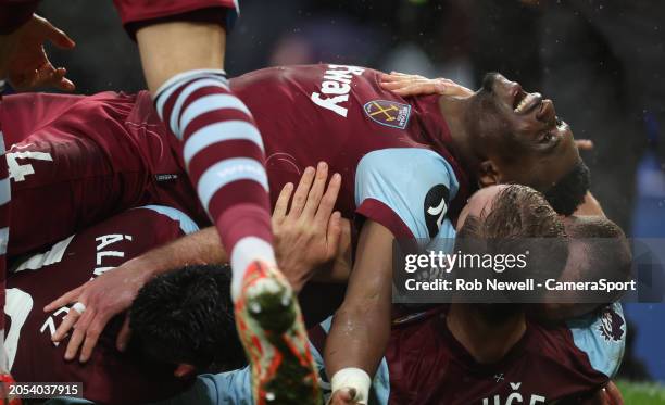 West Ham United's Edson Alvarez celebrates scoring his side's third goal as Mohammed Kudus lays on top of the pile of players during the Premier...