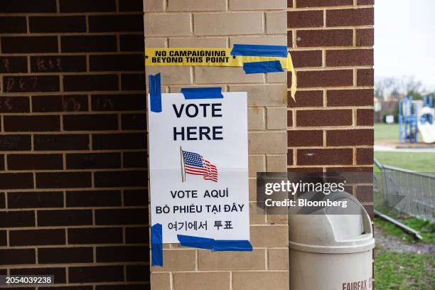 Vote Here" sign outside a polling station at Hutchison Elementary School in Herndon, Virginia, US, on Tuesday, March 5, 2024. This years Super...