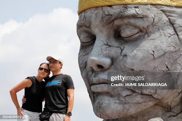 Tourists pose for a photo in the Pachamama sculpture by artist Jorge Jaramillo, aka Jordy, and 3D printer Juan David Escandon, which pays homage to...