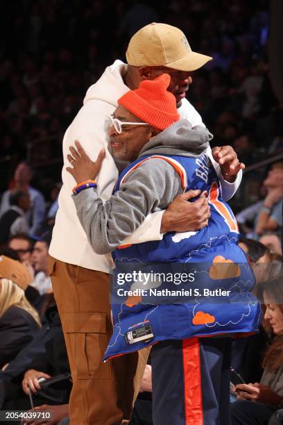 Michael Strahan embraces Spike Lee during the game between the Golden State Warriors and the New York Knicks on January 29, 2024 at Madison Square...