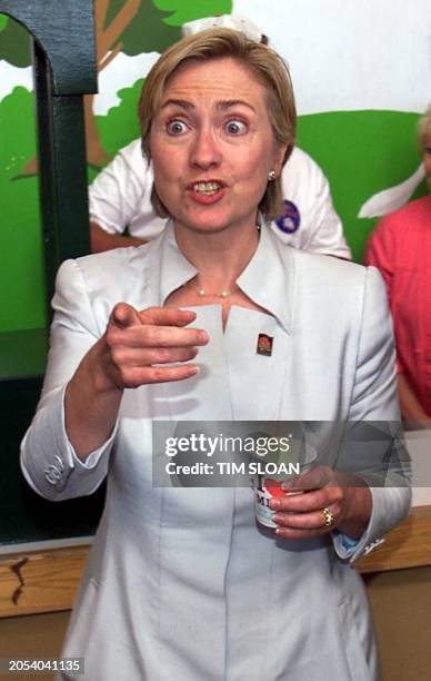 First Lady Hillary Rodham Clinton takes milk orders from the press at a dairy booth at the New York State Fair August 30 1999 in Syracuse, New York....