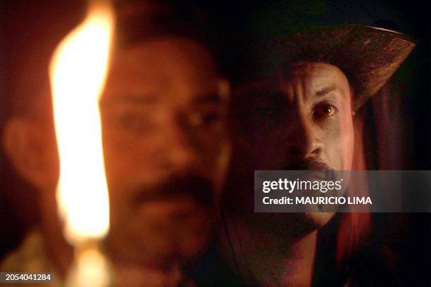 Two metalurgicos of one make brasilena of bicycles march under the light lamparas to wick, at dawn of the 15 of May of 2001, during a protest against...