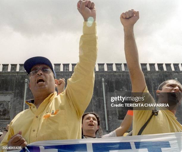 Workers from the Costa Rican Institute of Electricity shout slogans 20 March 2000 in front of the Legislative Assembly in San Jose, Costa Rica....