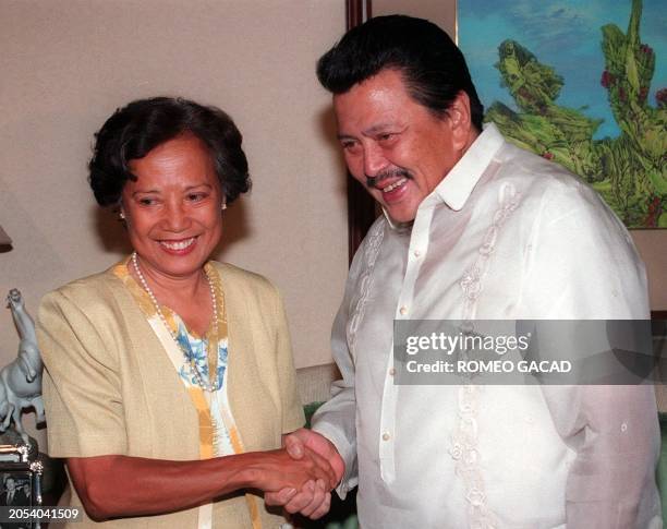 Leading opposition presidential candidate Joseph Estrada is congratulated in San Juan by Senator Letty Ramos Shahani who is a senior member of the...