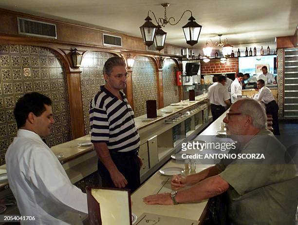 Patron attends a resturant where the lights are at 60% and the air conditioning works for only 4 hours during the lunchtime, 22 May 2001, in Rio de...