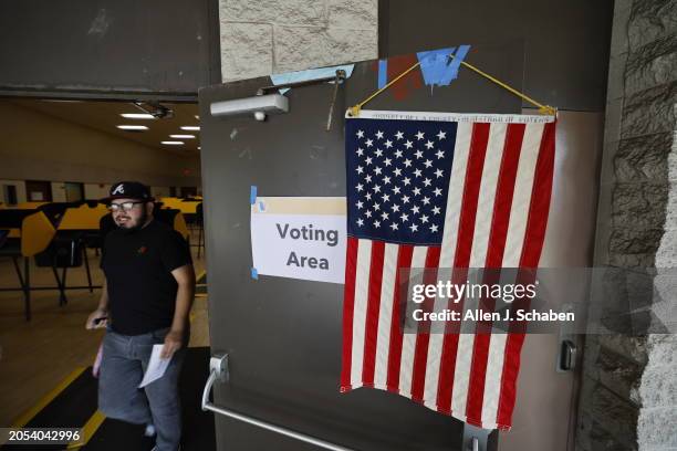 Boyle Heights, CA A flag is taped to the door as a voter exits after casting his ballot during Super Tuesday primary election at the Boyle Heights...