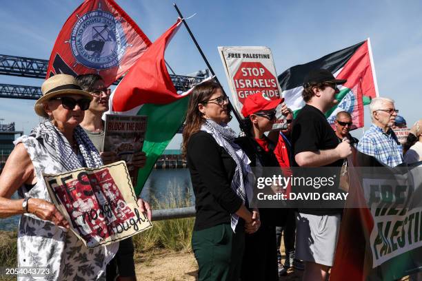Protesters hold flags and placards during a press conference at Port Botany on March 6 calling on the NSW and Federal governments to sanction Israel,...