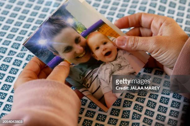 Ofri Bibas Levi, the sister in law of Israeli hostage kidnaped during the October 7 attack in southern Israel Shiri Bibas, holds a family picture of...