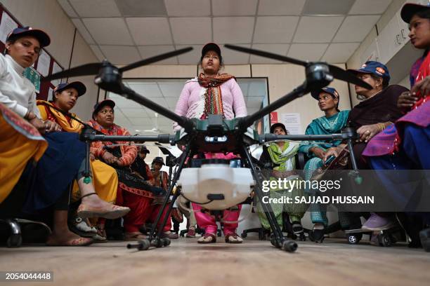 This photograph taken on February 28, 2024 shows women aspiring to be remote pilots attending a class under the government-backed "Drone Sister"...