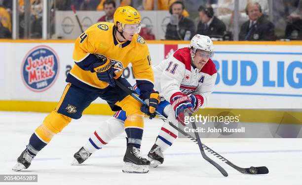 Gustav Nyquist of the Nashville Predators skates against Brendan Gallagher of the Montreal Canadiens during an NHL game at Bridgestone Arena on March...