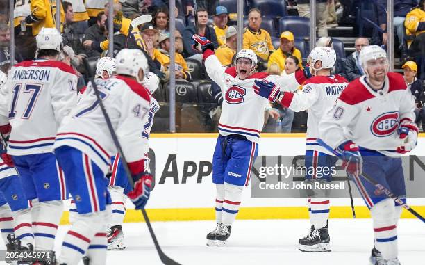 The Montreal Canadiens celebrate a 4-3 overtime win against the Nashville Predators during an NHL game at Bridgestone Arena on March 5, 2024 in...