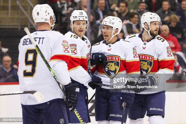 Florida Panthers center Evan Rodrigues celebrates with Florida Panthers left wing Matthew Tkachuk , Florida Panthers center Sam Bennett , and Florida...