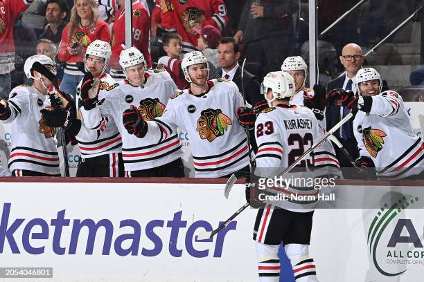 Philipp Kurashev of the Chicago Blackhawks celebrates with teammates on the bench after scoring a goal against the Arizona Coyotes during the second...