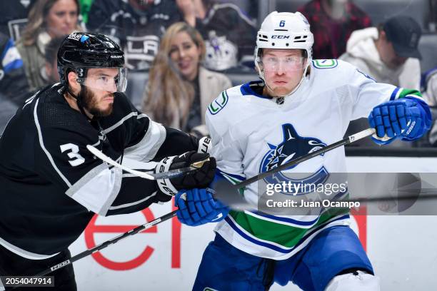 Matt Roy of the Los Angeles Kings and Brock Boeser of the Vancouver Canucks battle for position during the second period at Crypto.com Arena on March...