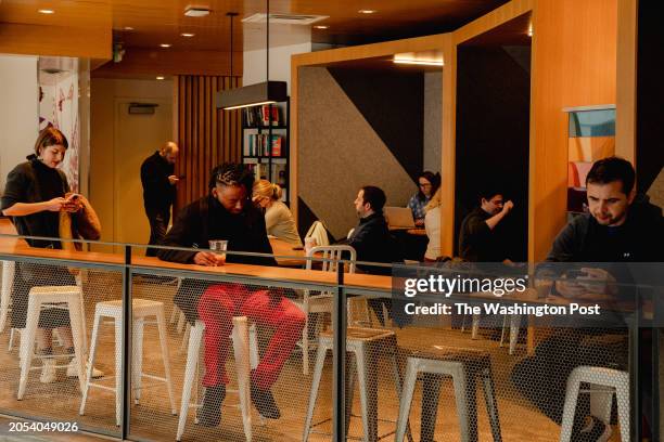 Single attendees wait for their matches during a shuffle speed dating event at Compass Coffee in Rosslyn, VA, on Saturday, March 2, 2024.