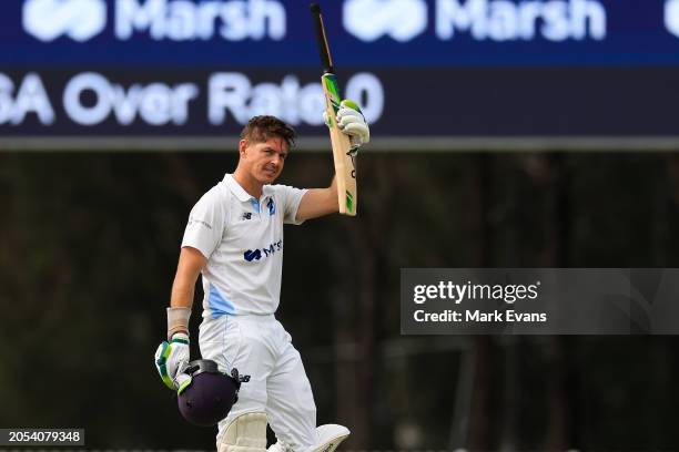 Daniel Hughes of New South Wales celebrates after reaching a century during the Sheffield Shield match between New South Wales and South Australia at...