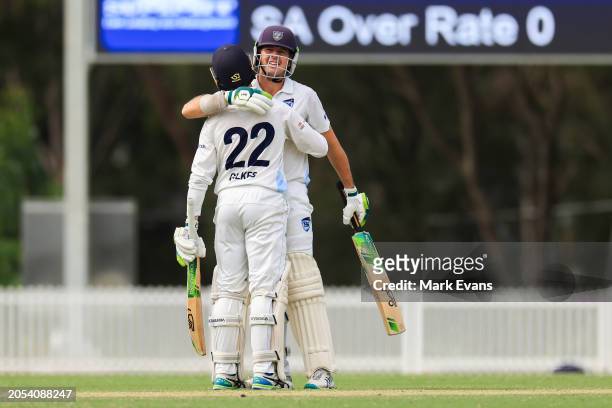 Daniel Hughes of New South Wales is congratulated by Matthew Gilkes of New South Wales after reaching a century during the Sheffield Shield match...