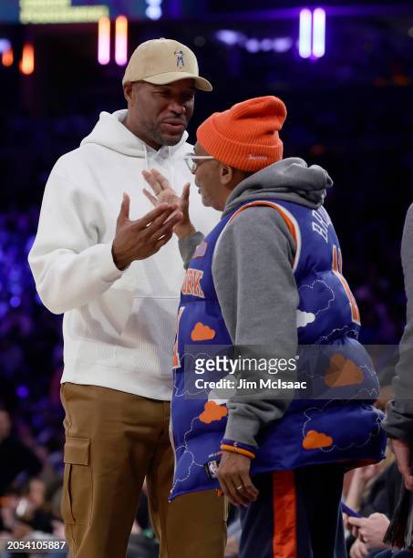 Former New York Giant Michael Strahan and film director Spike Lee attend a game between the New York Knicks and the Golden State Warriors at Madison...