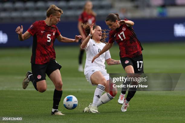 Maria Paula Salas of Costa Rica is closed in on by defenders Quinn and Jessie Fleming of Team Canada during the first half at BMO Stadium on March...