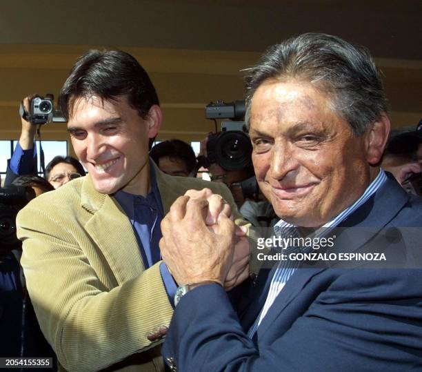 Presidential candidate and Social-Democrat Jaime Paz Zamora is congragulated by his son Jaime Paz Pereira, 30 June 2002 in La Paz, Boivia. Bolivians...