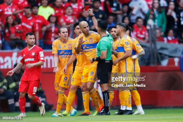 Adonai Escobedo, central referee, shows a red card to Sebastian Cordova of Tigres during the 10th round match between Toluca and Tigres UANL as part...