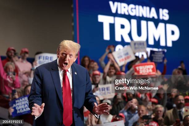 Republican presidential candidate and former President Donald Trump reacts to supporters as he arrives on stage at a Get Out the Vote Rally March 2,...