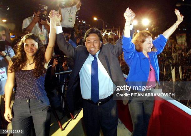 Candidate in the Peruvian presidential election, Alejandro Toledo from the center-left Peru Posible party, salutes some 10,000 supporters along with...